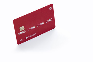 Wall Mural - Red credit card on white background with natural shadow