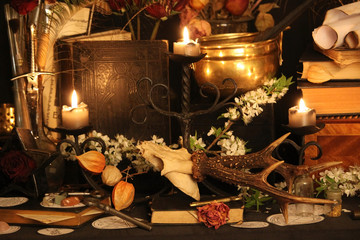 Wall Mural - Black candle Magic Ritual. Antique Magic Book. Witchcraft  Peacock feathers and candle background.