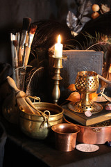 Black candle Magic Ritual. Antique Magic Book. Witchcraft  Peacock feathers and candle background.