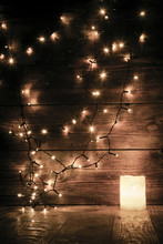Christmas Decorations And Lights On Wooden Background
