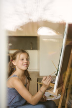 Little Girl Drawing On Canvas At Home