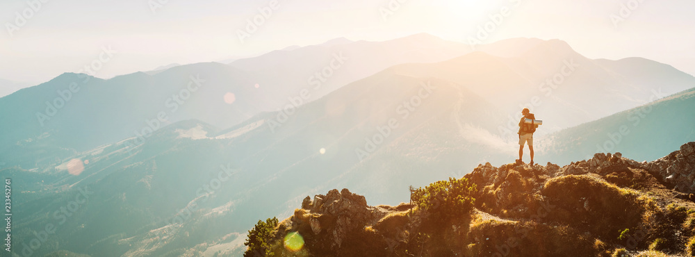 Mountain hiker with backpack tiny figurine stay on mountain peak with beautiful panorama - obrazy, fototapety, plakaty 