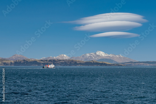Fotografie, Obraz Ferry sailing between Oban and the Isle of Mull with snow capped highland peaks
