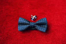 Men's Accessories. Blue Bow-tie And Cufflinks Isolated On Red Background. Groom Details