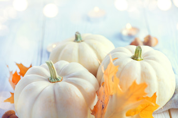 Thanksgiving background. Holiday scene. Wooden table, decorated with pumpkins, autumn leaves and candles