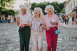 © Yakobchuk Olena - Waist up photo of old stylish women. White-haired females holding each other and laughing
