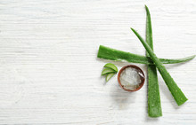 Flat Lay Composition With Aloe Vera Leaves On Wooden Background. Space For Text