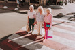© Yakobchuk Olena - Top view of stylish smiling grannies are staying on the street while holding shopping bags
