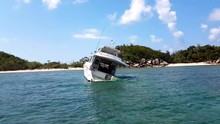 Ship Wreck Crashed In Shallow Tropical Waters With Island In Background.