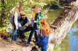© zinkevych - Eco energy. Positive bearded man sitting in front of children while showing them solar battery model
