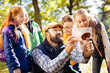 © zinkevych - Digital innovations. Cheerful bearded man holding a mushroom while taking photos on his tablet