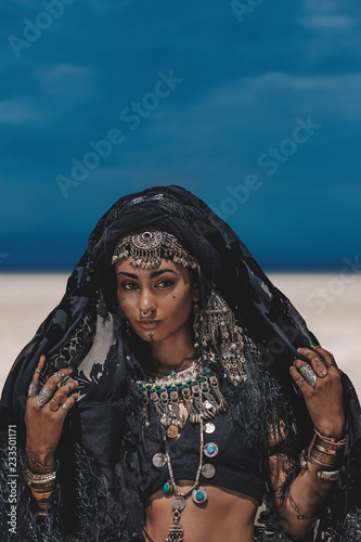 Plakat Beautiful young stylish tribal dancer. Woman in oriental costume outdoors