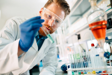 Attractive student of chemistry working in laboratory