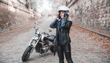 Fototapeta  - Beautiful biker woman with motorcycle.
