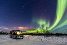 Beautiful Green Northern Lights And Camper With Light
