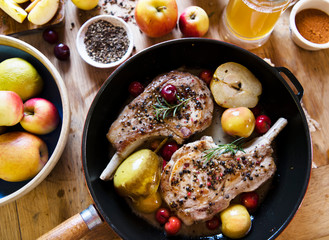 Wall Mural - Pork chop with apples in a pan food photography recipe idea