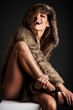 © Iván Antúnez - Young woman wearing a fur coat and smiling.
