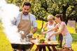 © ivanko80 - Family enjoying bbq party in their garden