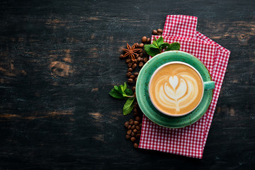 Cappuccino. Coffee with milk. On a black wooden background. Top view. Free copy space.