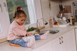 © cherryandbees - Little girl sitting on kitchen counter and playing