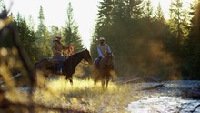 Riders On Horse In Valley Stream Rocky Mountains Canada