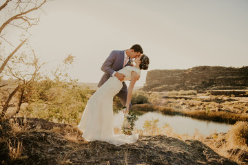 Wall Mural - Beautiful Couple on their Wedding day in front of landscape