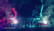 © DJ Creative Studio - Party Night Club Disc Jockey (DJ) Entertainment with EDM Dance Music Mixer CD Players with Lighting and Smoke Effect During Holiday