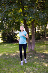 Wall Mural - Senior woman doing exercise in the green park