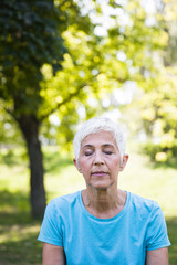 Wall Mural - Portrait of senior woman in the park