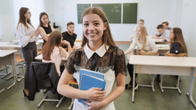 Portrait Of A Young Russian Senior School Graduate Showing Success With The Help Of A Finger In The Up.