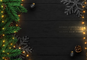 Wall Mural - Christmas composition on wooden background. Xmas decoration design, bauble ball, snowflake color black, gold light garland, pine cone, fir branches. Balck realistic Wood texture. Flat lay, top view.