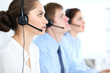 © rogerphoto - Call center operators at work. Focus at  business woman in headset