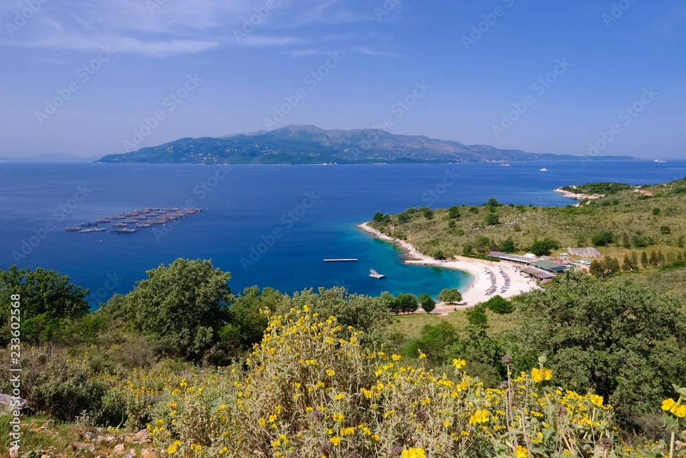 Coast with beach Gjiri i Hartes, behind the Greek island of Corfu ...