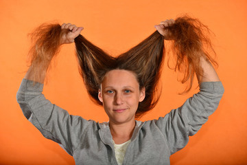 Wall Mural - The girl holds her hair up and they bloom on the fly on a yellow background.