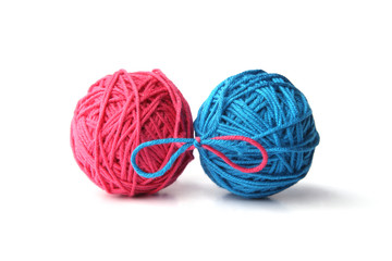 Wall Mural - two pink and blue cotton thread balls tied in bow isolated on white background. different color pink