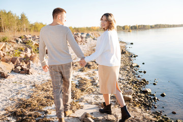 Young family having a romantic walk near the water