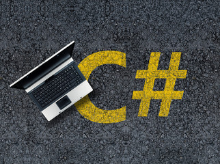 Wall Mural - C sharp programming language. Laptop on c# drawn with paint on road asphalt