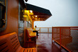 © Cavan for Adobe - Full length of businessman sitting on bench in ferry against clear sky during dusk