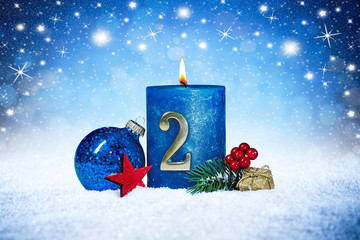 second sunday of advent blue candle with golden metal number red decoration one on wooden planks in snow front of silver panorama bokeh background