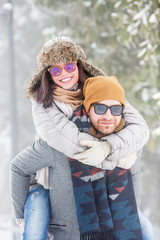 Poster - Happy young couple in snow outdoors