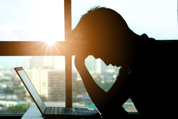 Woman sitting work computer stressed not happy at her desk . Health concept