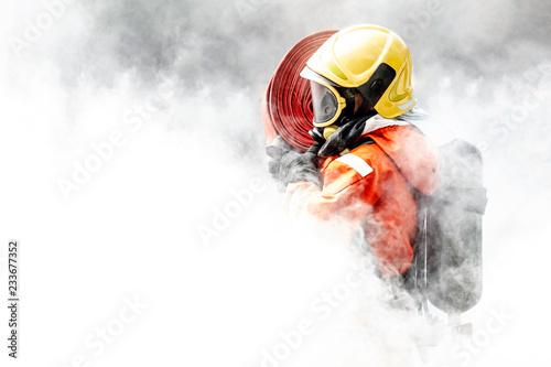 Photographie Firefighter in the midst of fire and smoke.