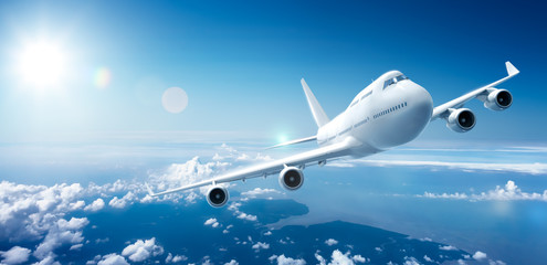 Wall Mural - airplane flying above clouds