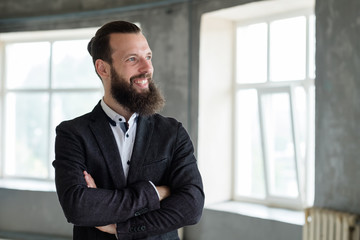 smiling business man with arms crossed. office dress code and stylish corporate look.