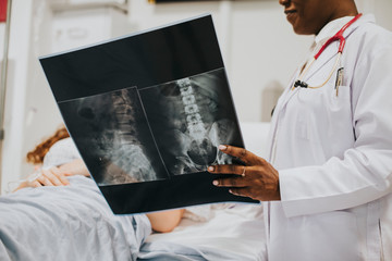 Wall Mural - Physician showing a patient the X-ray results