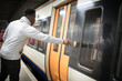 Man pushing a button to open the train doors