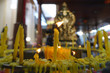 © smilekorn - Lighted candle and incense for Buddha. Selective focus.