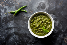 Healthy Indian Green Chutney Or Sauce Made Using Coriander, Mint And Spices. Isolated Over Moody Background. Selective Focus