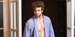 Sexy bachelor lover concept. Sexy attractive macho tousled hair coming out through bedroom door. Guy attractive lover posing seductive. Seductive lover full of desire. Man confident lover near door