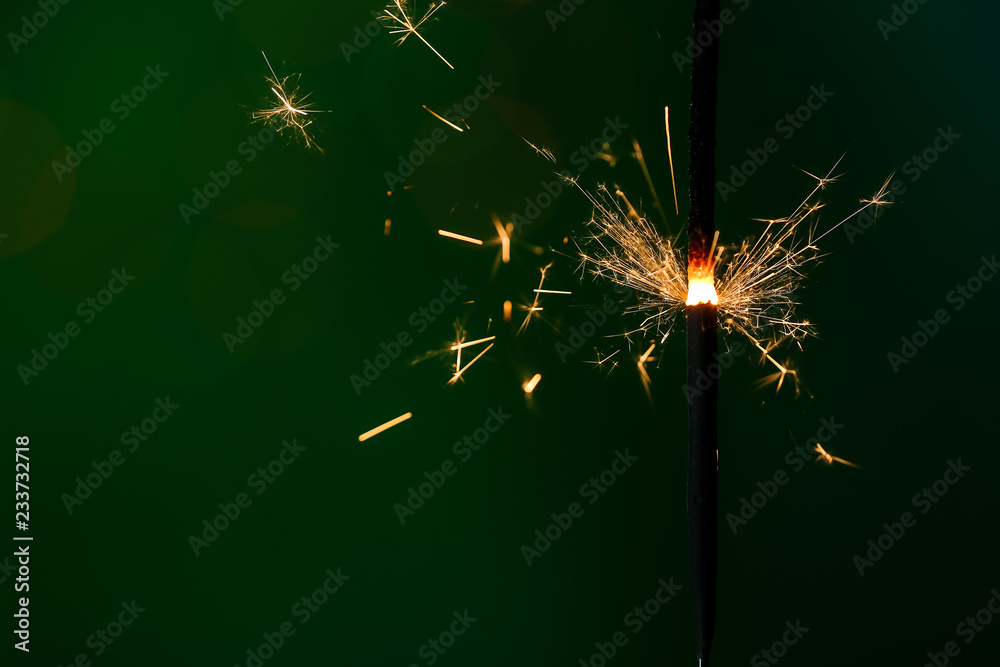 Festive Christmas sparkler on dark color background